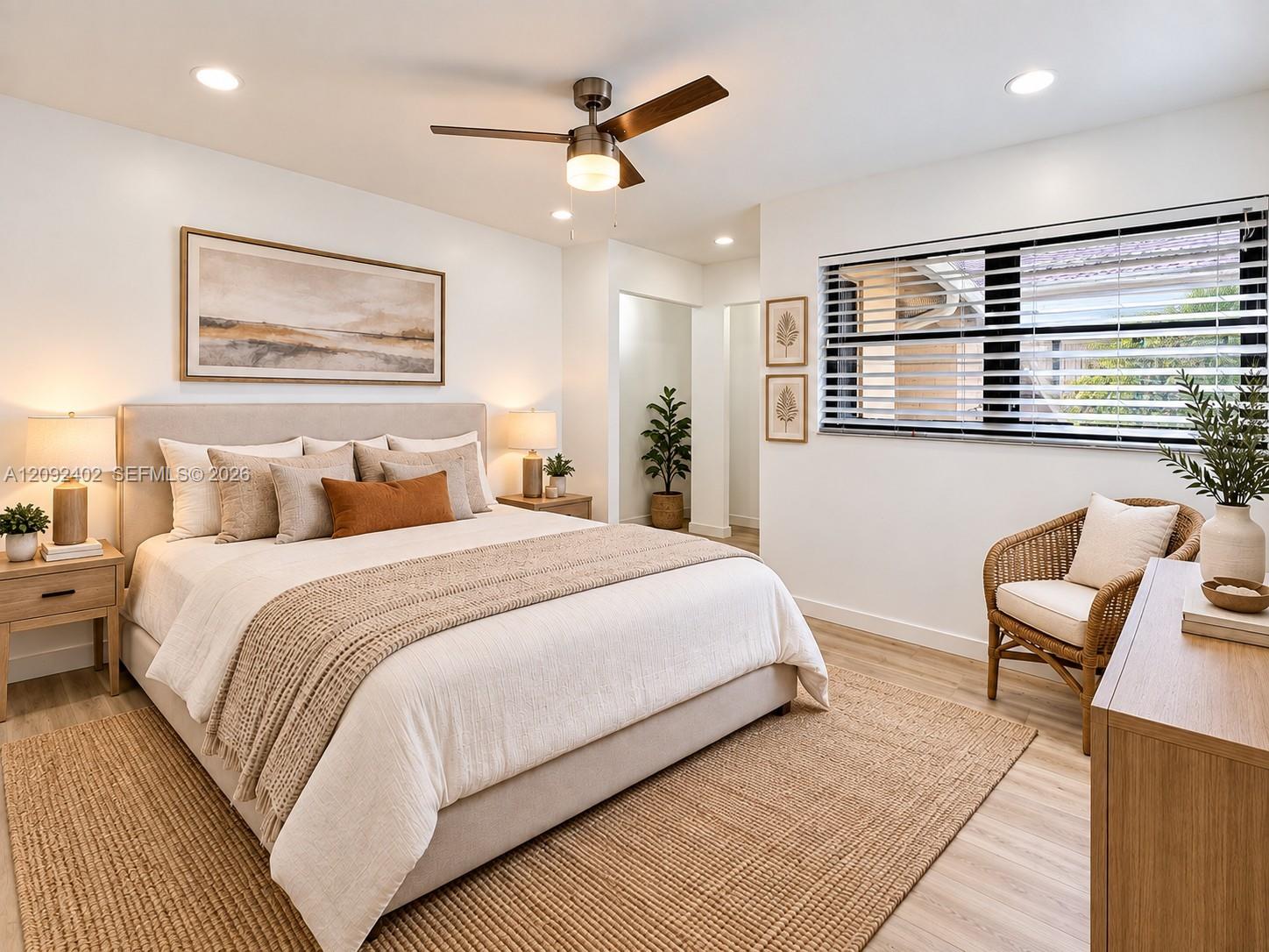 TV console & plants virtually staged for illustrative purposes. Neutral-toned interior featuring wood-finish flooring, recessed lighting, and a modern ceiling fan with an integrated light fixture