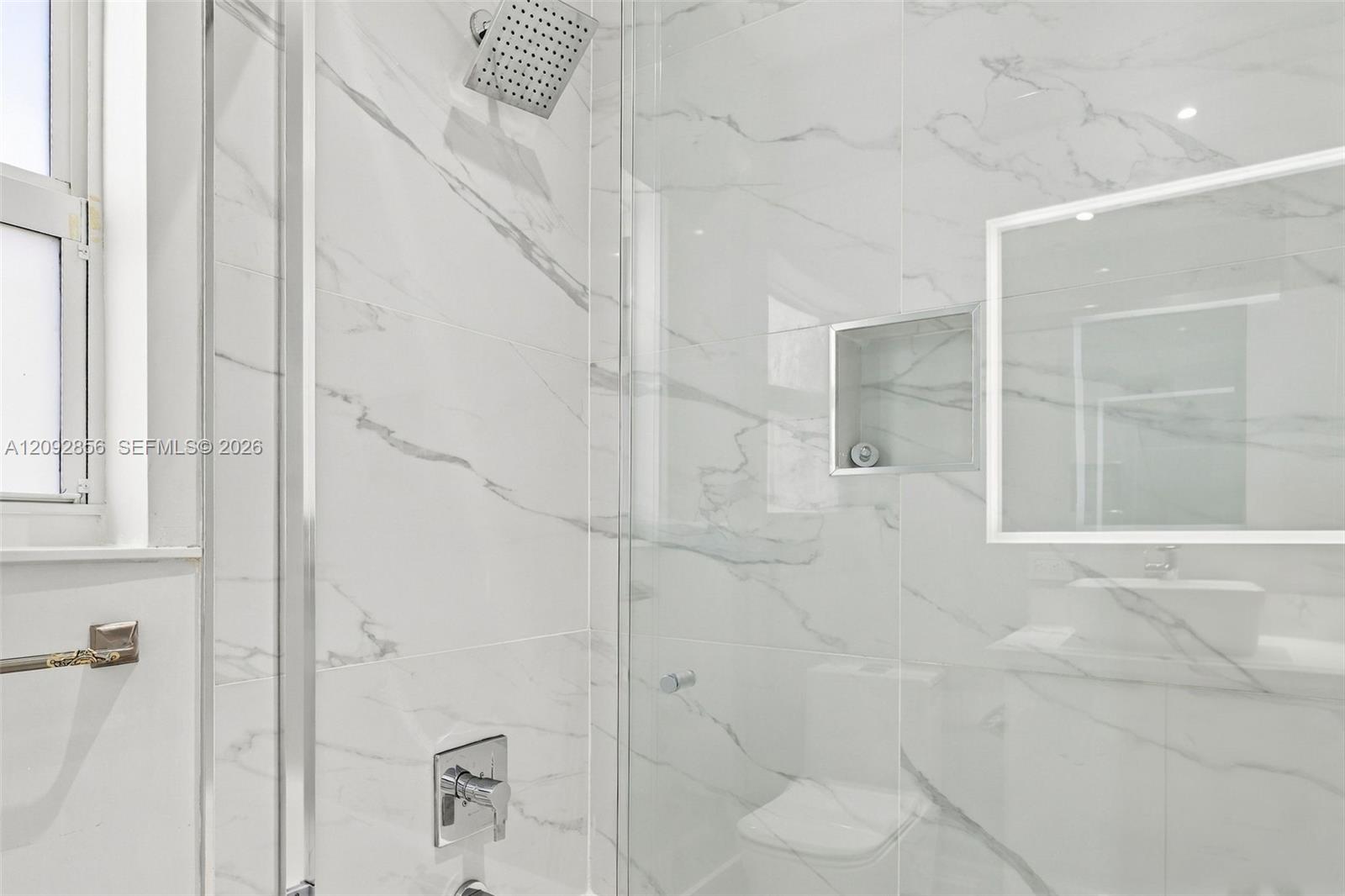 3rd bathroom - 2nd floor - Full-height large-format wall tiling, glass-enclosed shower, built-in recessed storage niche, square rainfall showerhead, and chrome fixtures