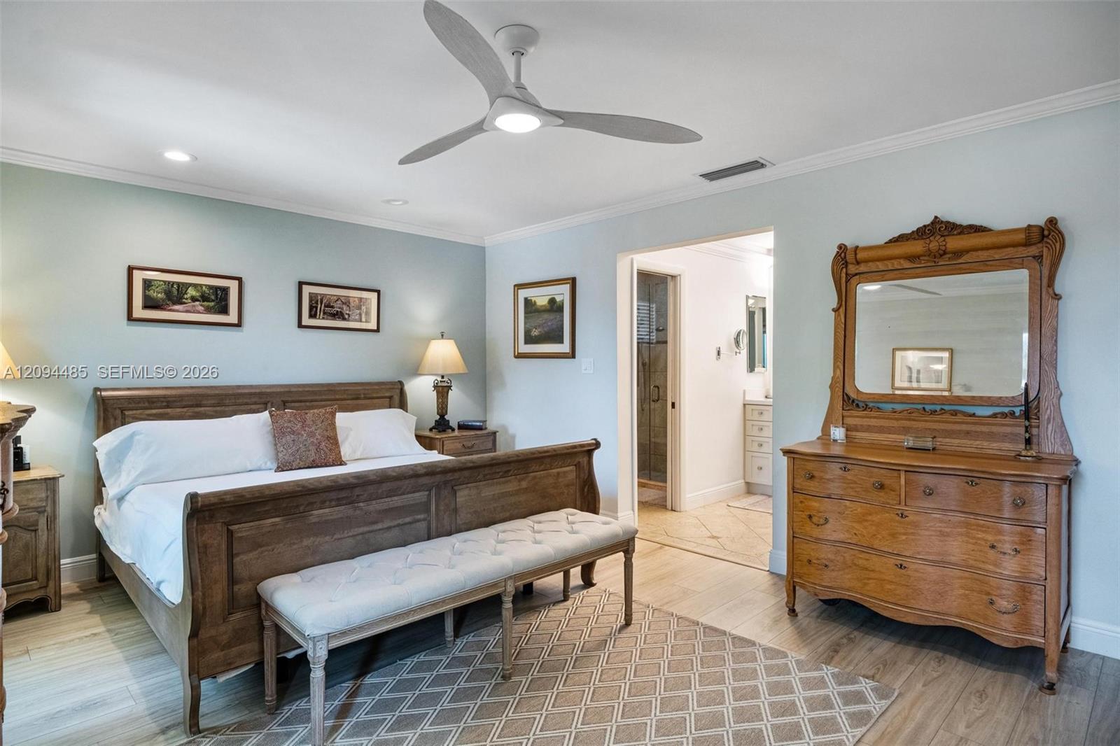 Spacious room featuring wood-finish flooring, recessed lighting, and a modern three-blade ceiling fan
