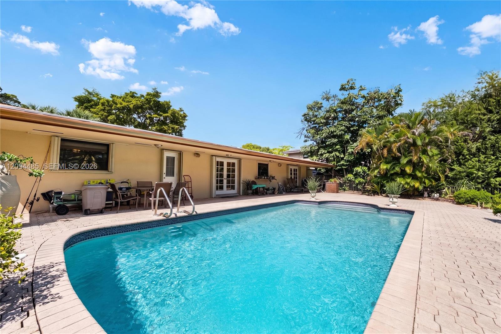 In-ground swimming pool with masonry paver surround, expansive patio, and mature landscaping In-ground swimming pool with masonry paver surround, expansive patio, and mature landscaping