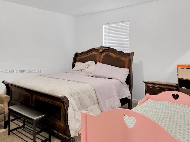Neutral interior featuring carpeted flooring and a horizontal window with fitted blinds