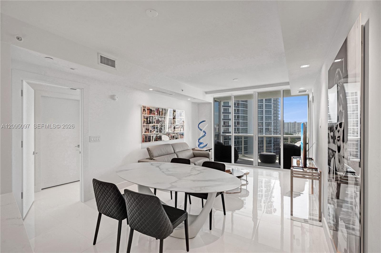 Open-concept living space featuring high-gloss tile flooring, recessed lighting, and floor-to-ceiling glass sliding doors