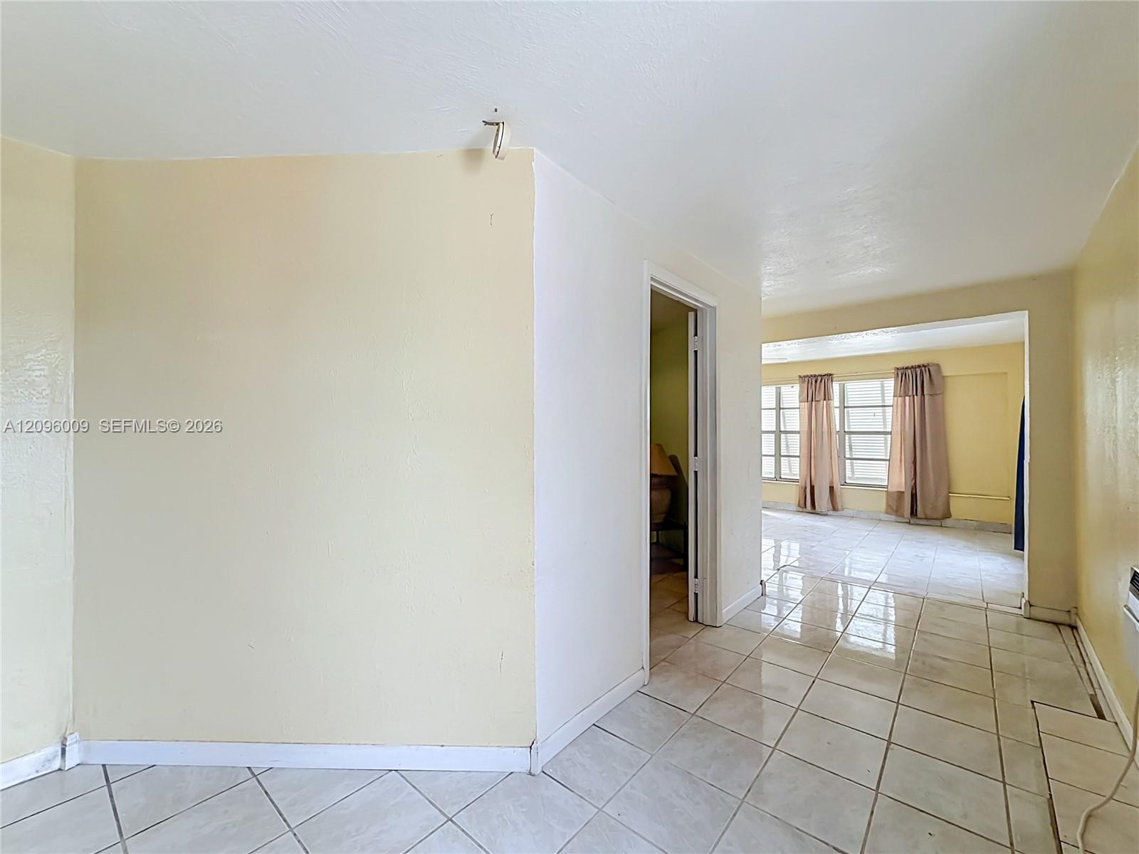 Interior space featuring large-format ceramic tile flooring and multi-pane windows