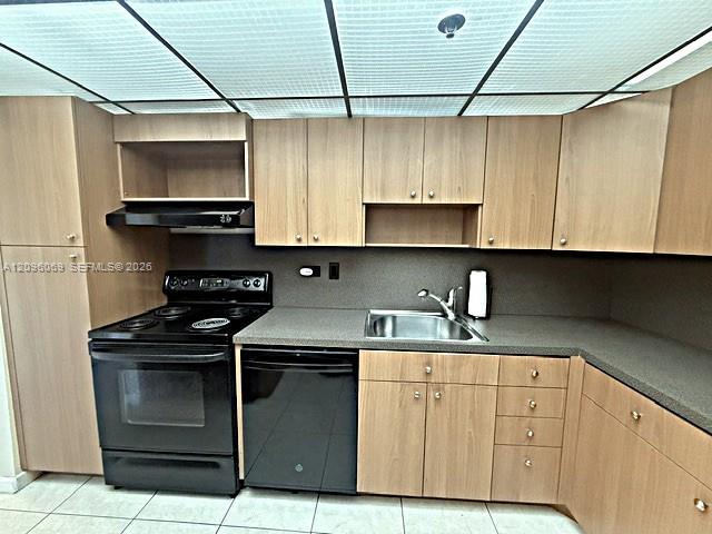 Kitchen featuring light-finish cabinetry, black appliances, textured countertops, stainless steel sink with metal faucet, and grid-pattern ceiling lighting