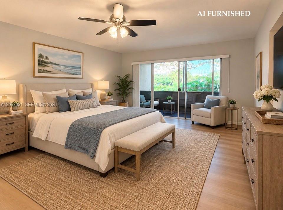 Neutral-toned interior space featuring light wood-finish flooring, a ceiling fan with integrated lighting, and a large sliding glass door providing access to a private balcony