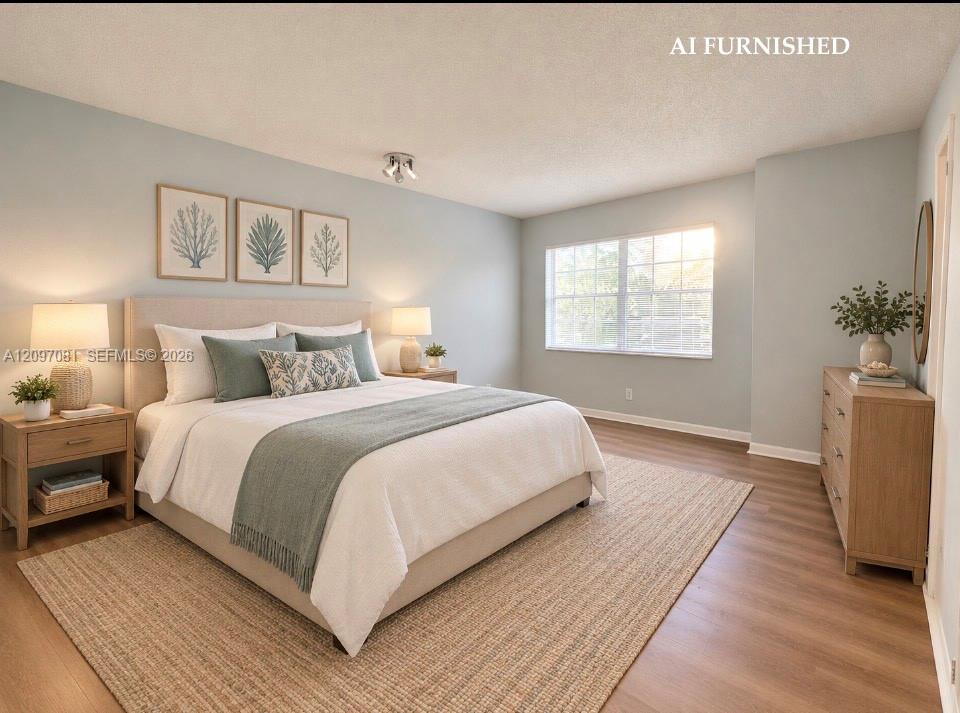 Neutral-toned wall paint, wood-finish flooring, and a multi-pane window with natural light exposure