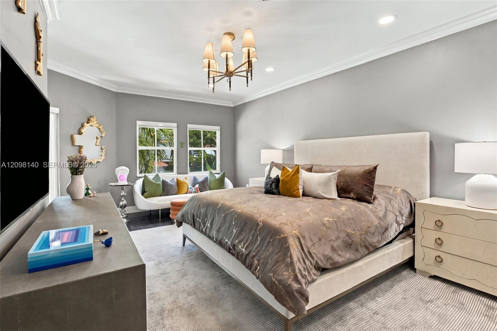 Spacious room featuring crown molding, recessed lighting, a multi-arm chandelier, and two windows