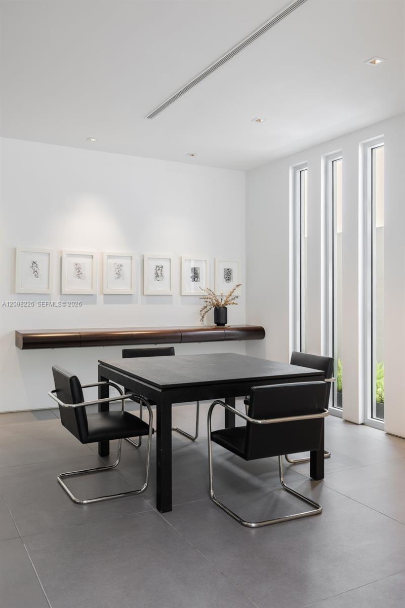 Wall-mounted custom wood shelving, large-format tile flooring, recessed ceiling lighting, and floor-to-ceiling vertical windows