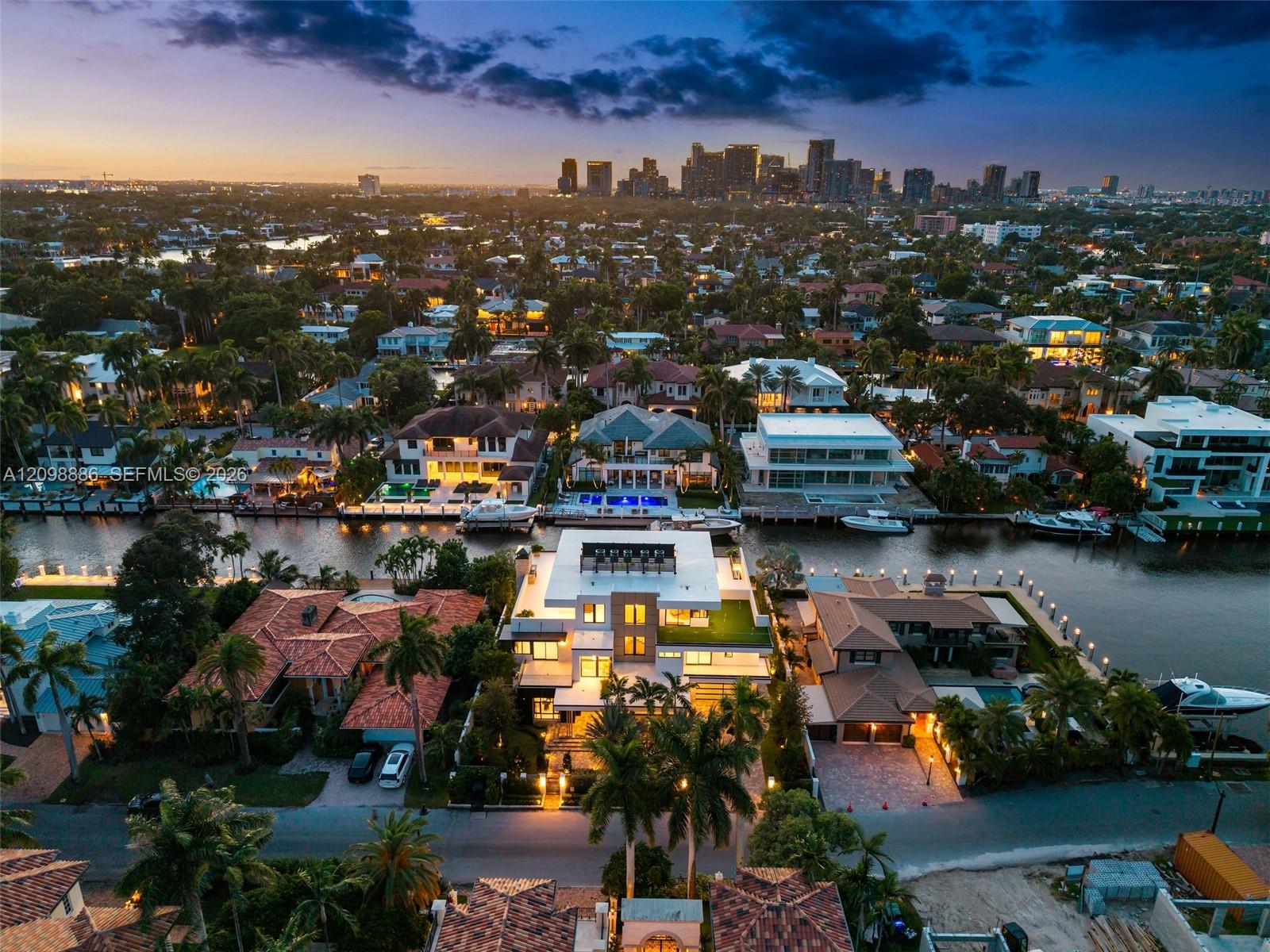 Waterfront property featuring a flat roof architectural design, multi-level terraces, private pool, and bulkhead dockage