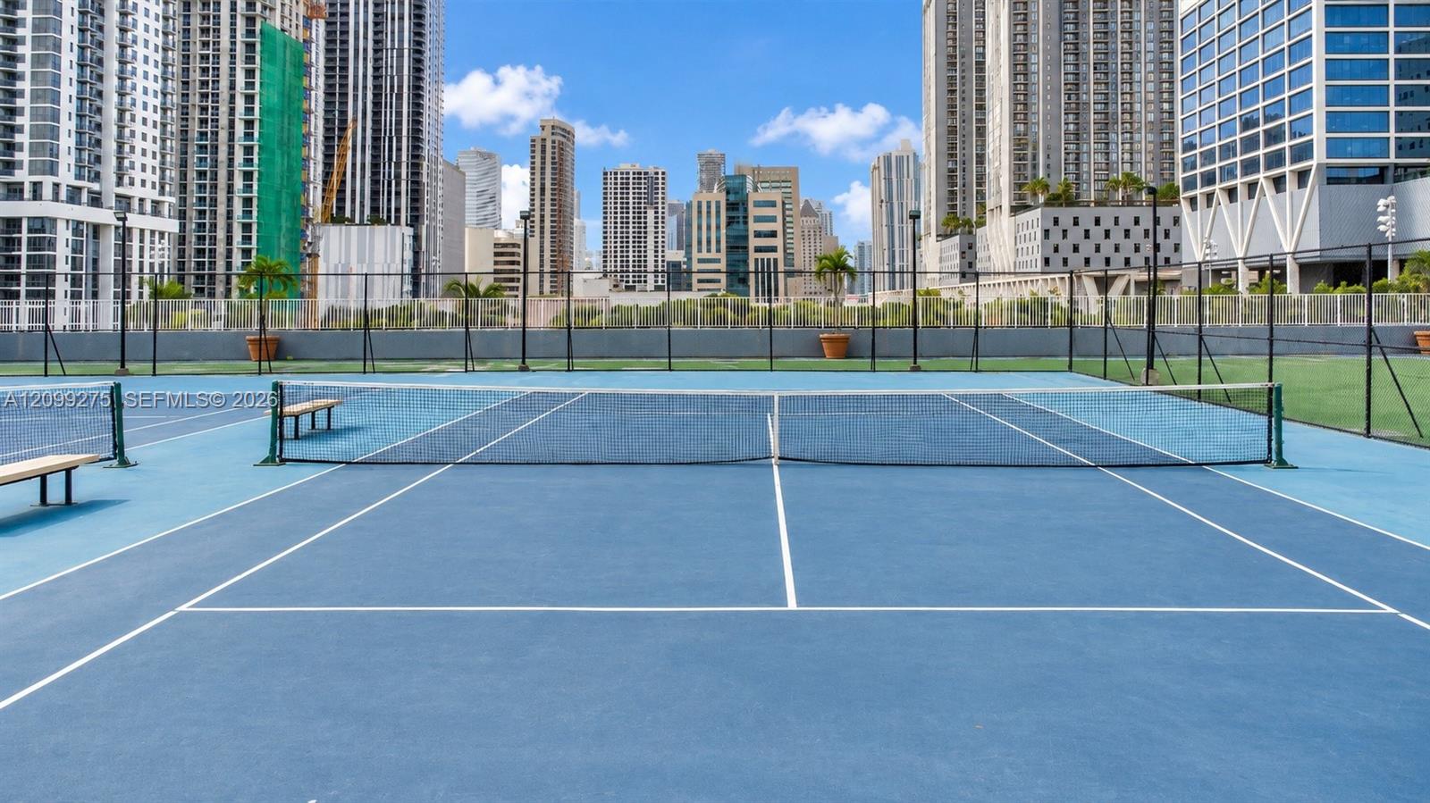 Tennis courts surrounded by Miamis impressive downtown skyline, offering residents a scenic outdoor space for recreation and an active lifestyle.