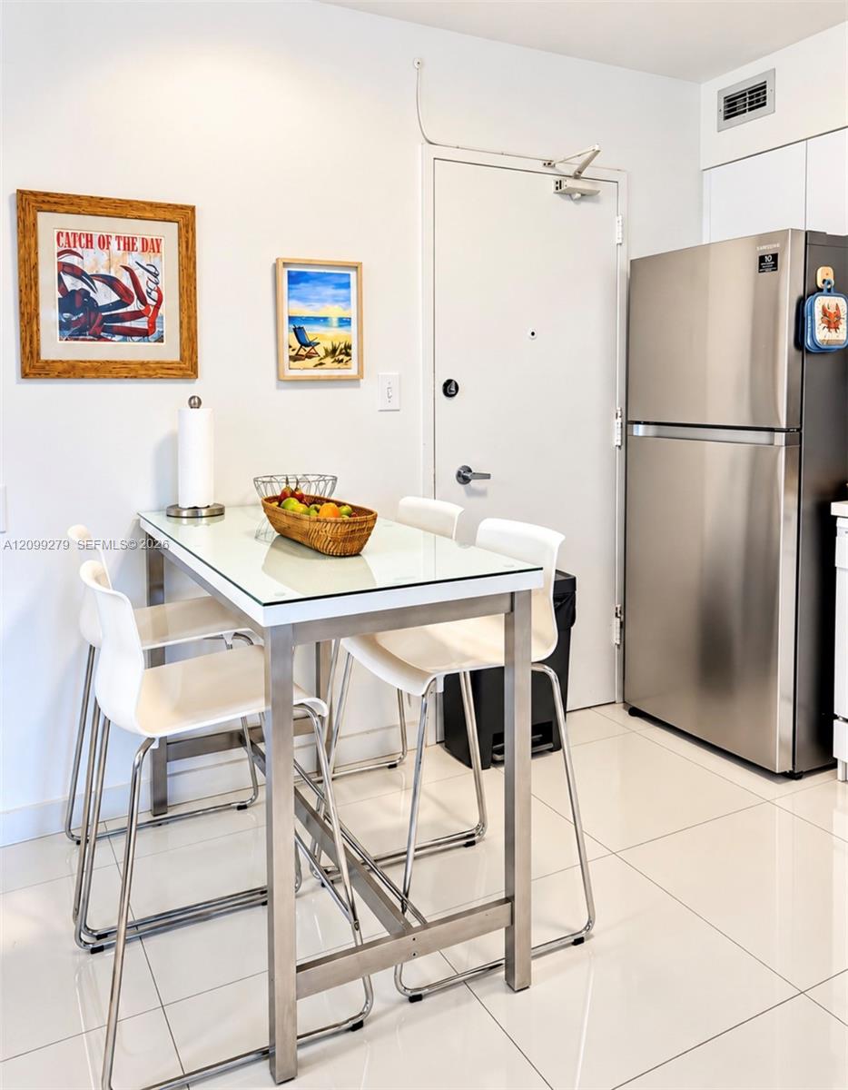 Stainless steel refrigerator and high-gloss tile flooring
