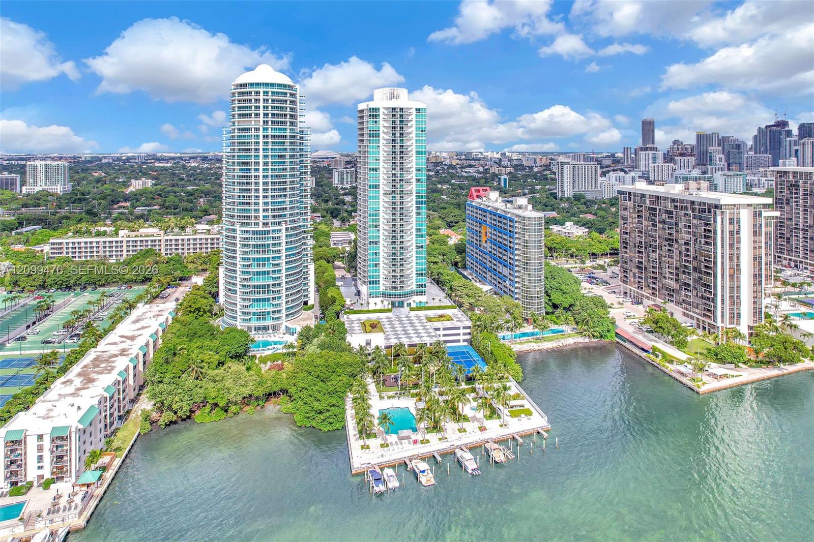 High-rise residential towers featuring private boat slips, swimming pools, tennis courts, and expansive waterfront positioning