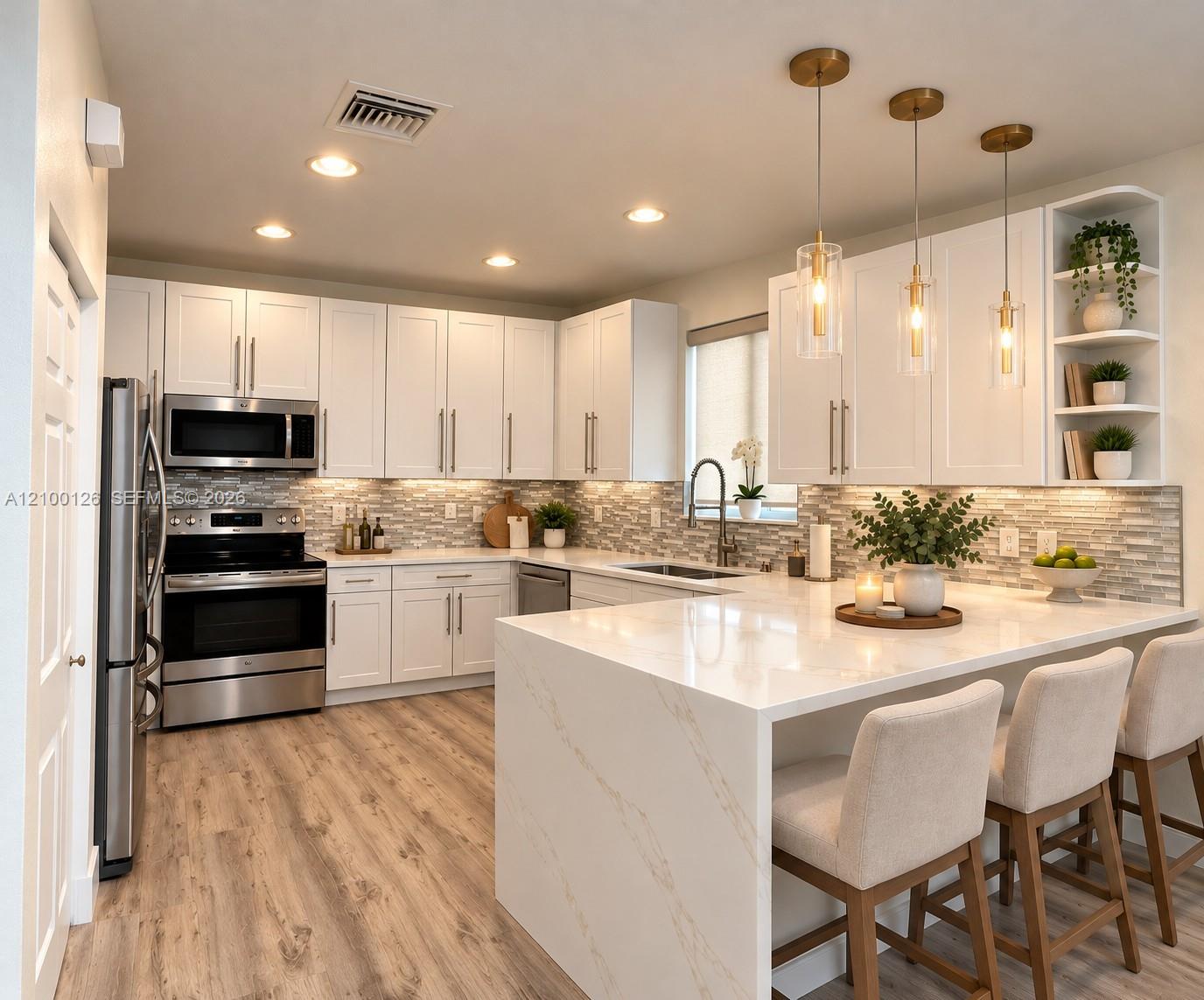 Kitchen featuring white shaker-style cabinetry, quartz waterfall-edge island, stainless steel appliances, multi-tonal linear tile backsplash, and wood-finish flooring