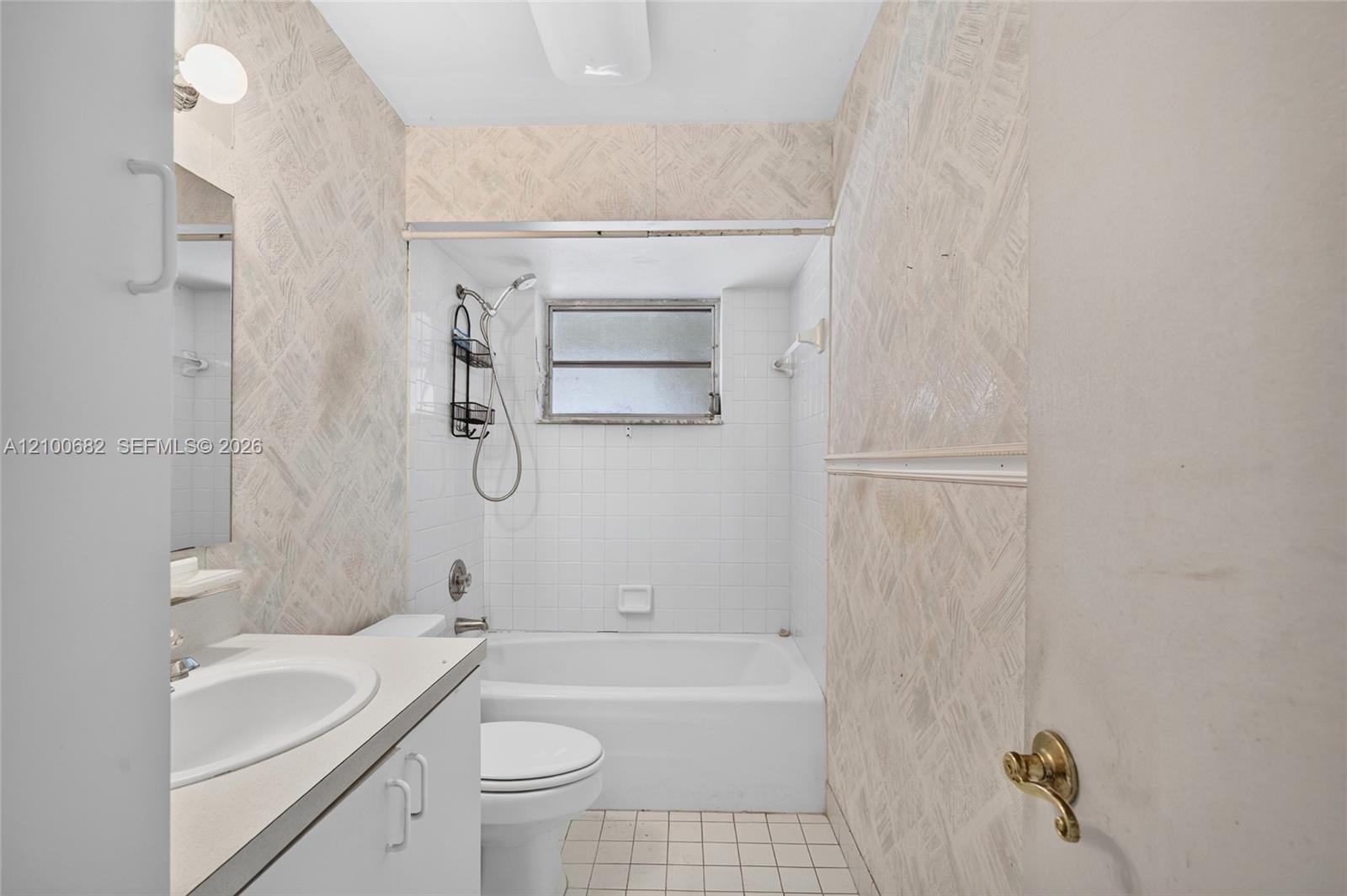 Hall bathroom featuring a vanity with a white countertop and oval sink, a combined tub and shower enclosure *