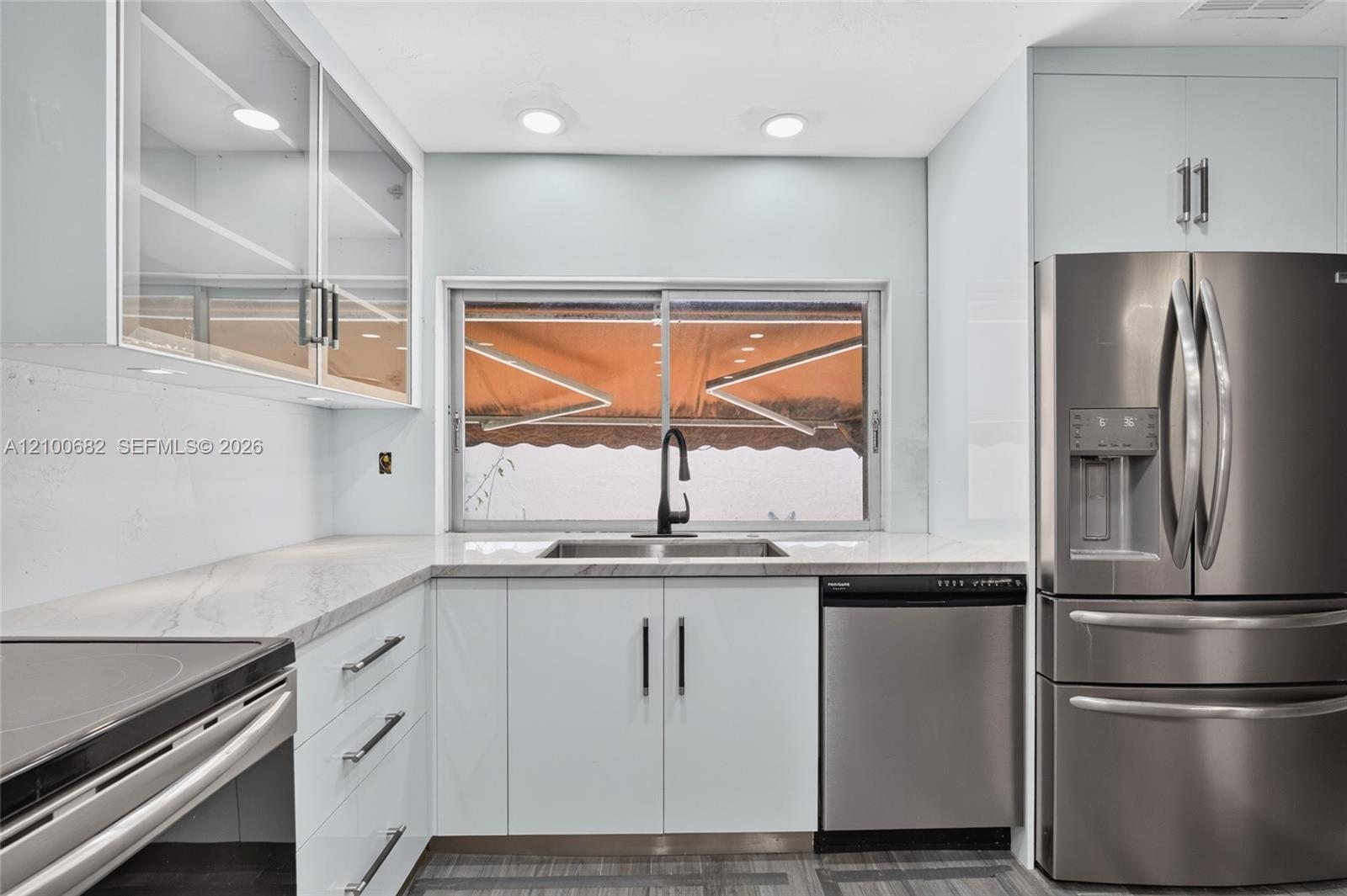 Kitchen featuring with views to the back yard through the large window over the sink*