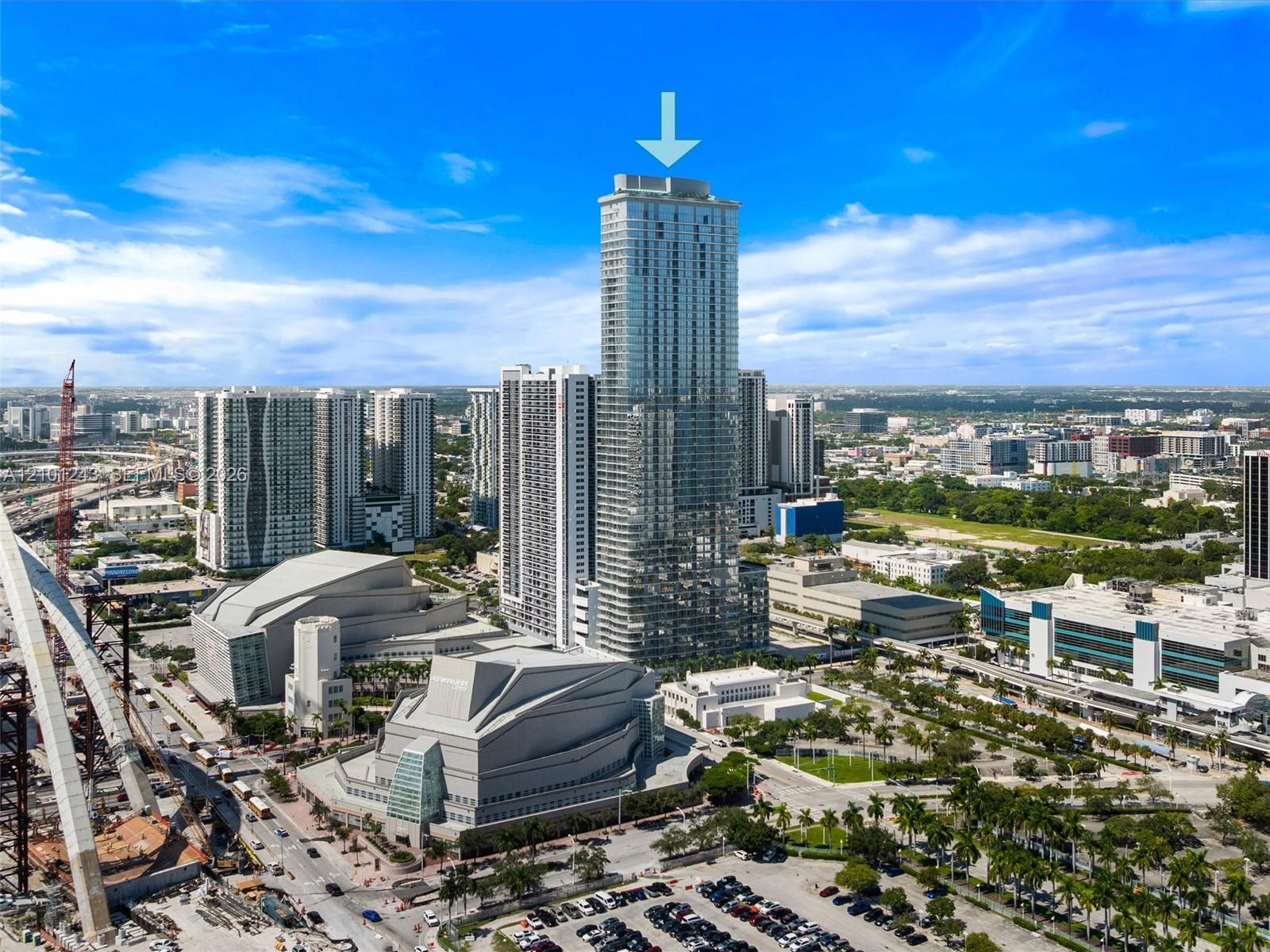 High-rise tower featuring a glass facade and a prominent central location within a metropolitan urban district