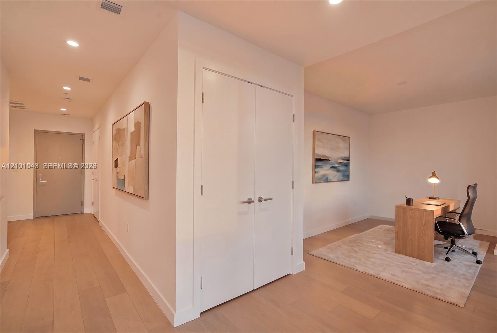 Interior space featuring wood-finish flooring, recessed lighting, and double-door closet cabinetry Interior space featuring wood-finish flooring, recessed lighting, and double-door closet cabinetry
