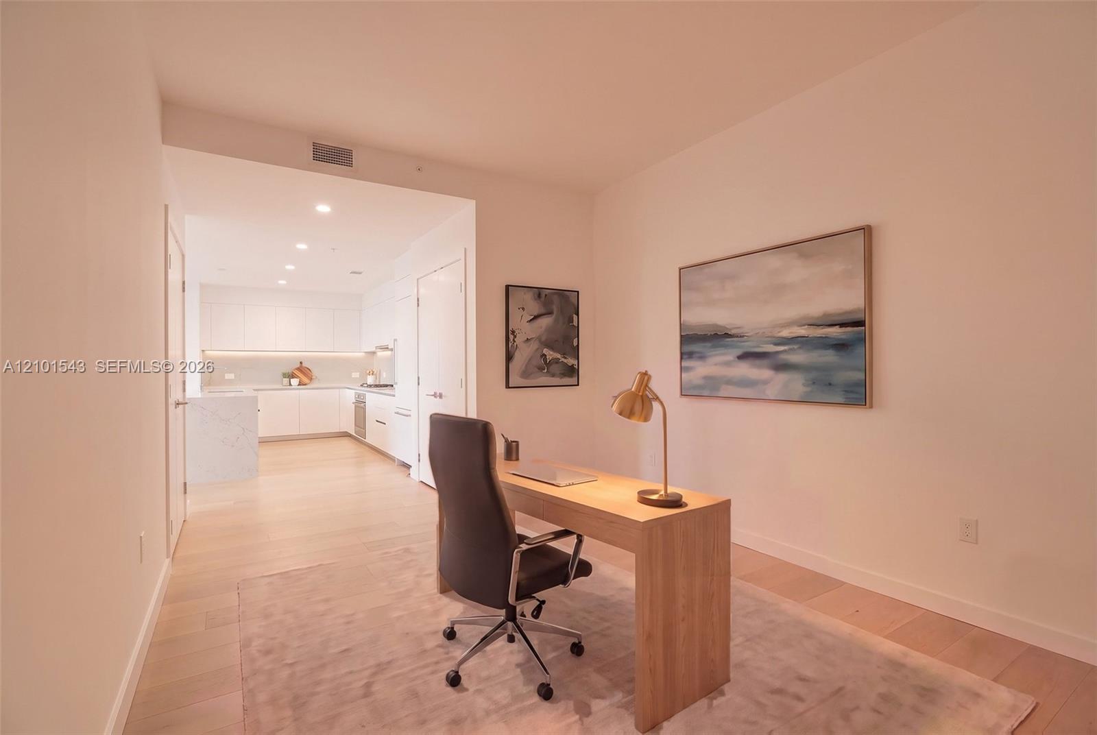 Light-toned wood-finish flooring, white flat-panel cabinetry, quartz countertops, and recessed ceiling lighting Light-toned wood-finish flooring, white flat-panel cabinetry, quartz countertops, and recessed ceiling lighting