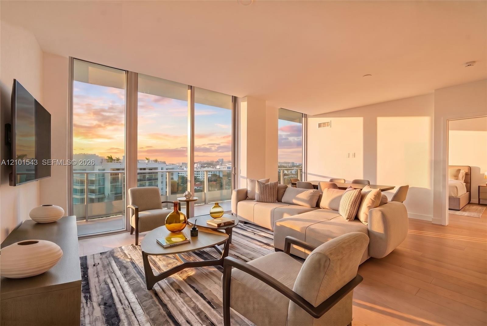 Floor-to-ceiling windows, wood-finish flooring, and a private balcony featuring a glass railing and expansive sky backdrop Floor-to-ceiling windows, wood-finish flooring, and a private balcony featuring a glass railing and expansive sky backdrop