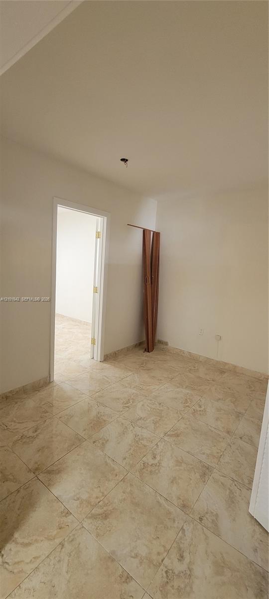 Neutral-toned tile flooring and white wall finishes