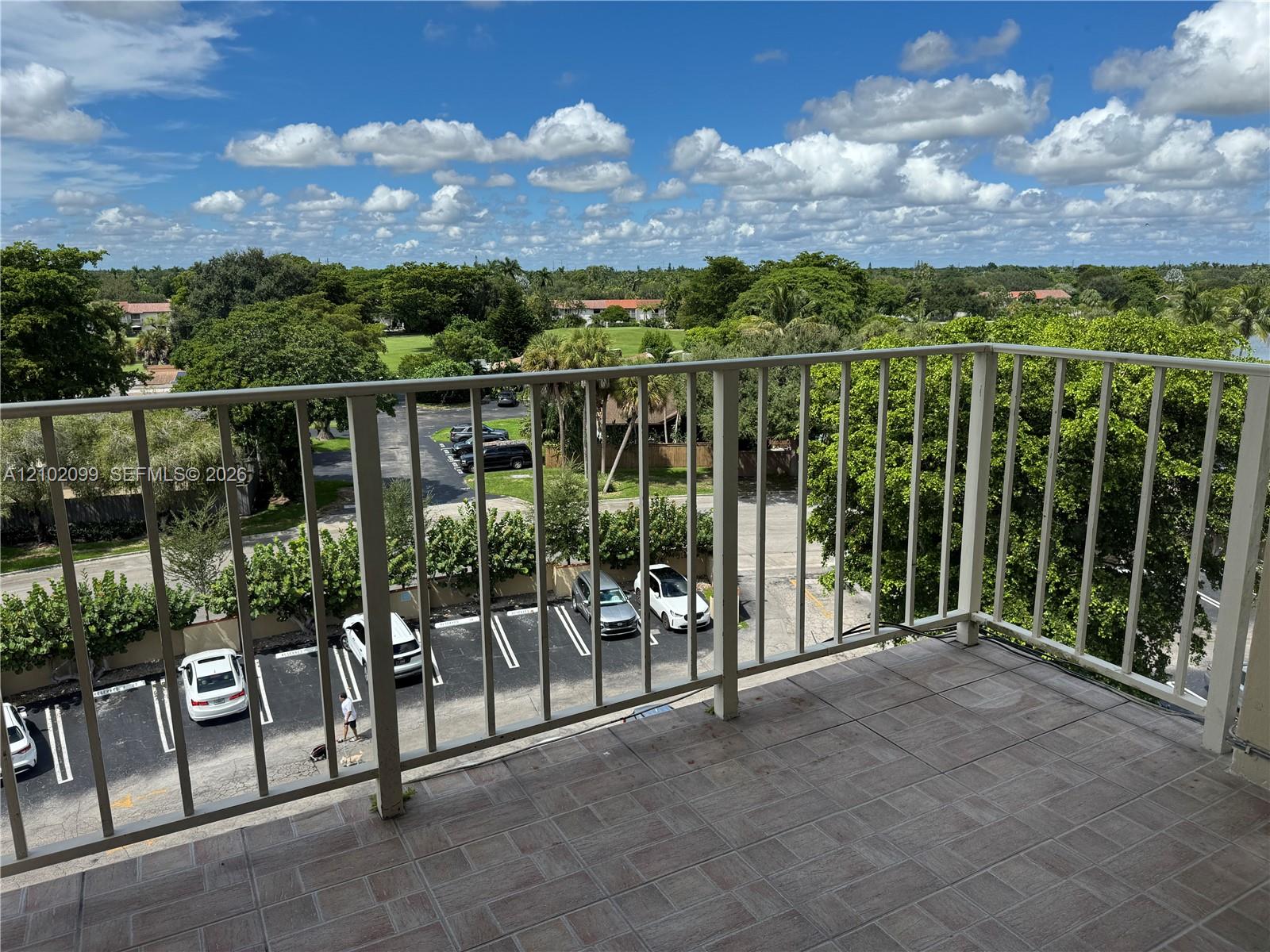 Private balcony featuring ceramic tile flooring and a vertical metal railing Private balcony featuring ceramic tile flooring and a vertical metal railing