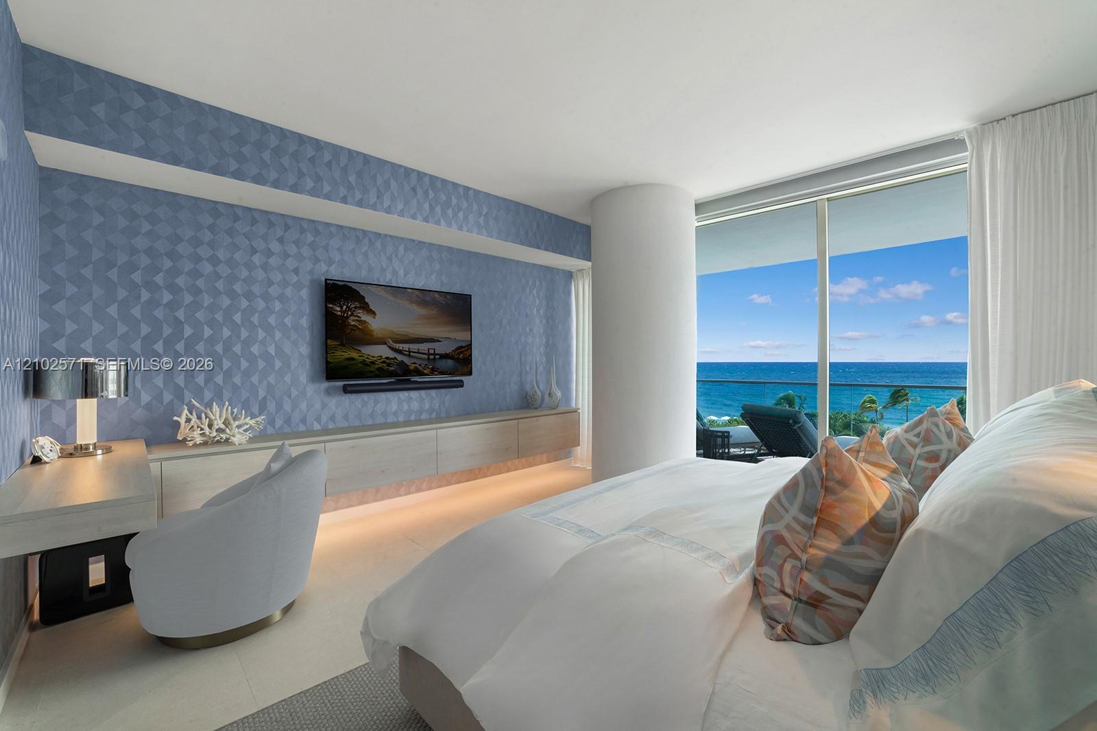Floor-to-ceiling windows, textured accent wall, built-in cabinetry, and tile flooring