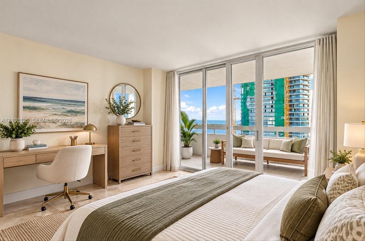 Floor-to-ceiling glass sliding doors, covered private balcony, light-toned stone flooring, neutral wall color palette