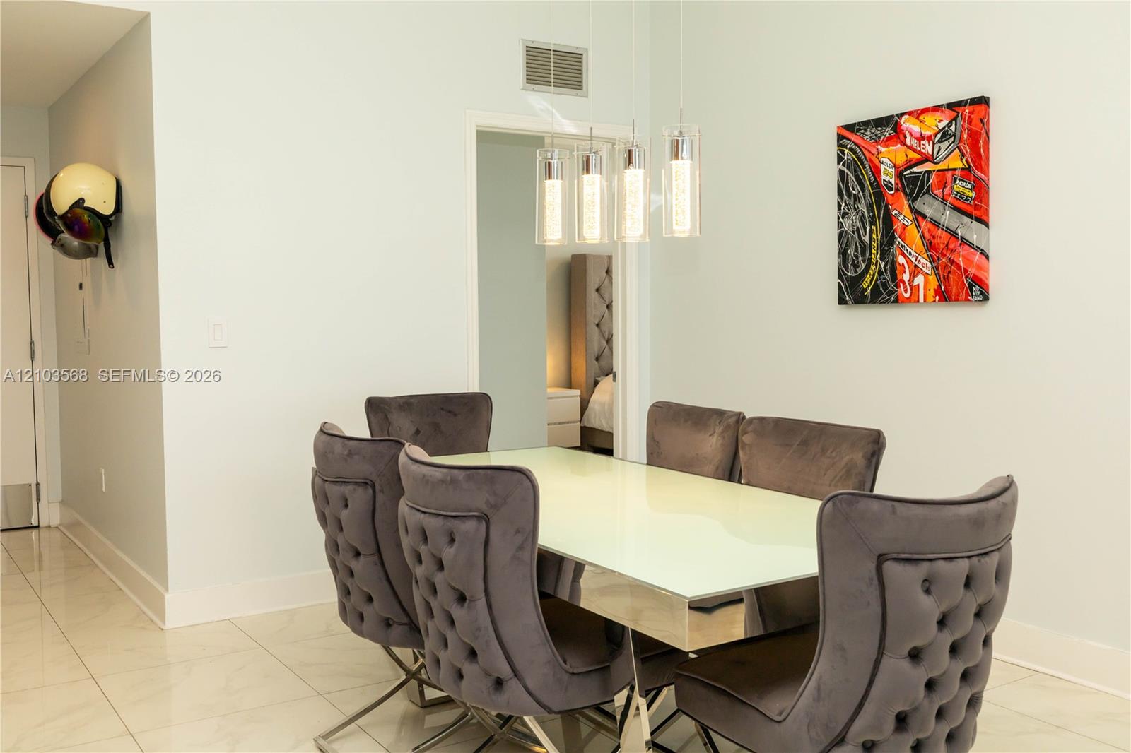 Polished tile flooring and modern four-light pendant fixture with cylindrical glass shades