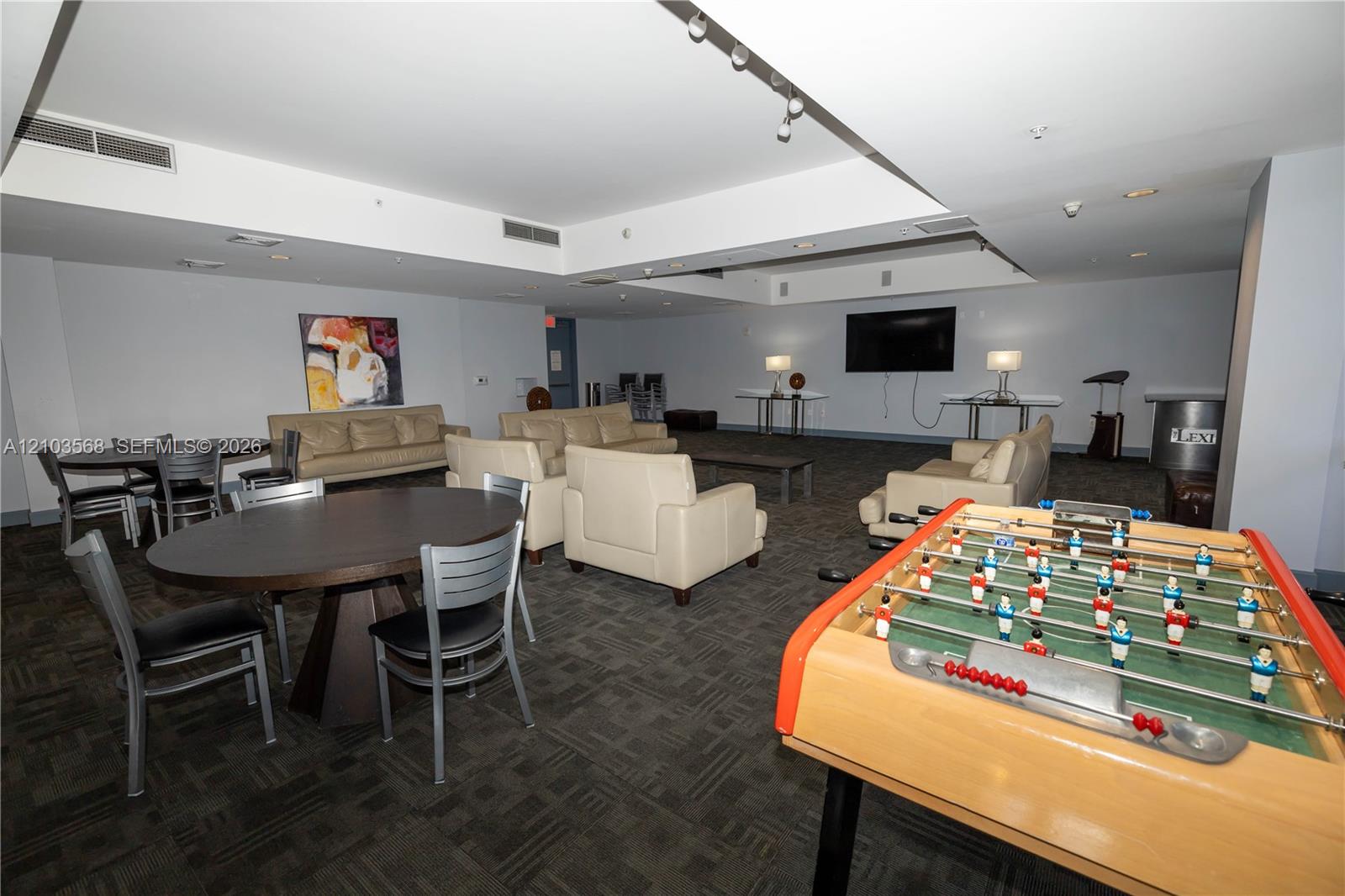 Expansive common area featuring recessed ceiling lighting, a neutral color palette, and wall-to-wall carpeting
