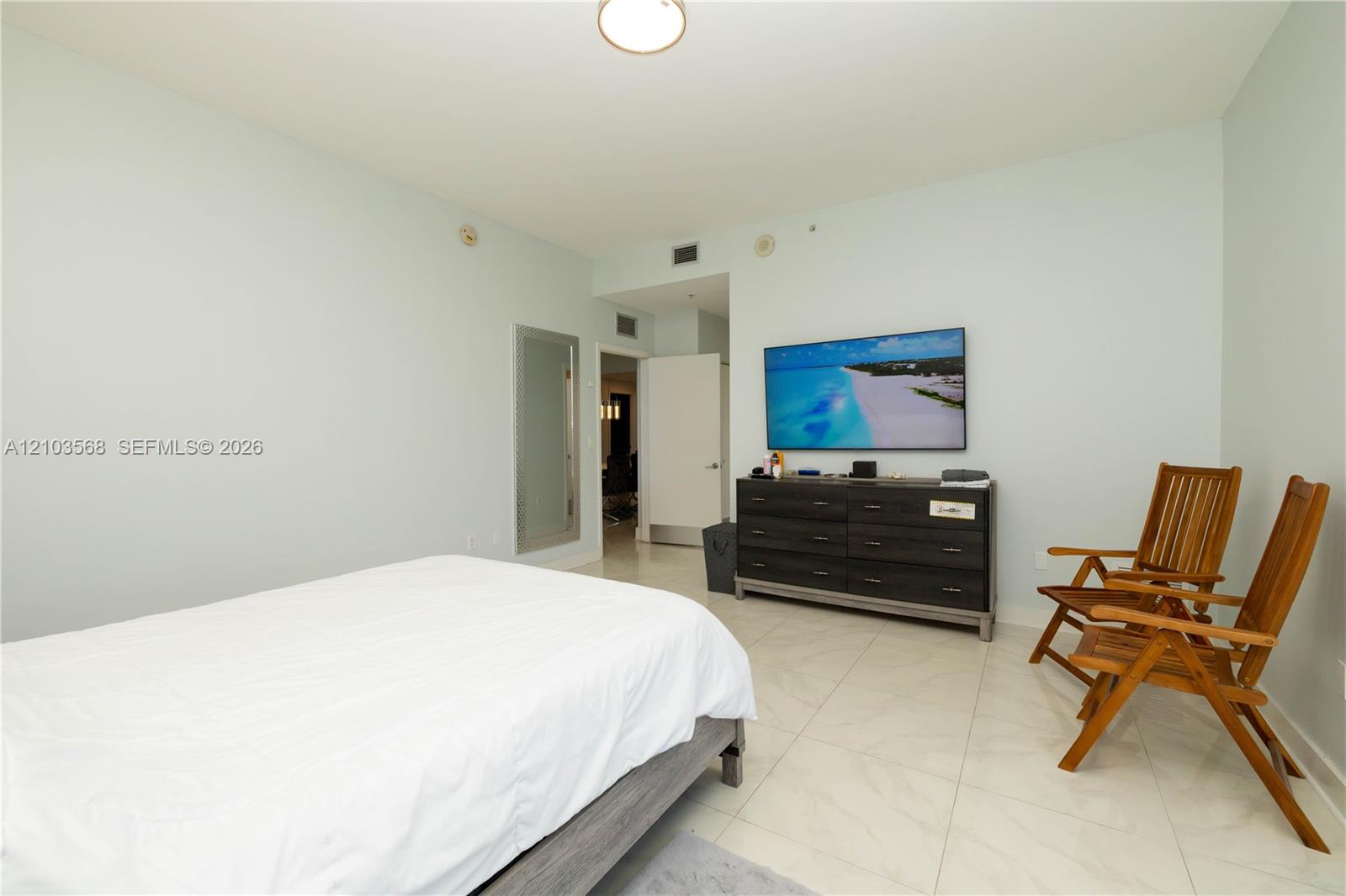 Interior space featuring large-format tile flooring, a flush-mount ceiling light fixture, and a neutral wall finish