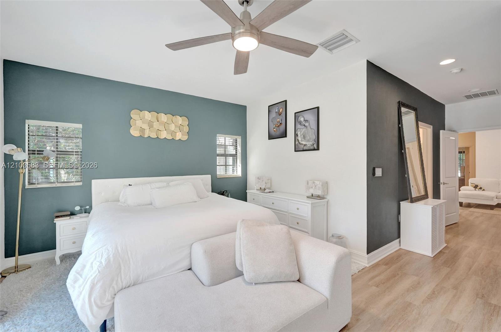 Room featuring dual-tone painted walls, recessed lighting, wood-finish flooring, and a ceiling fan with integrated light fixture