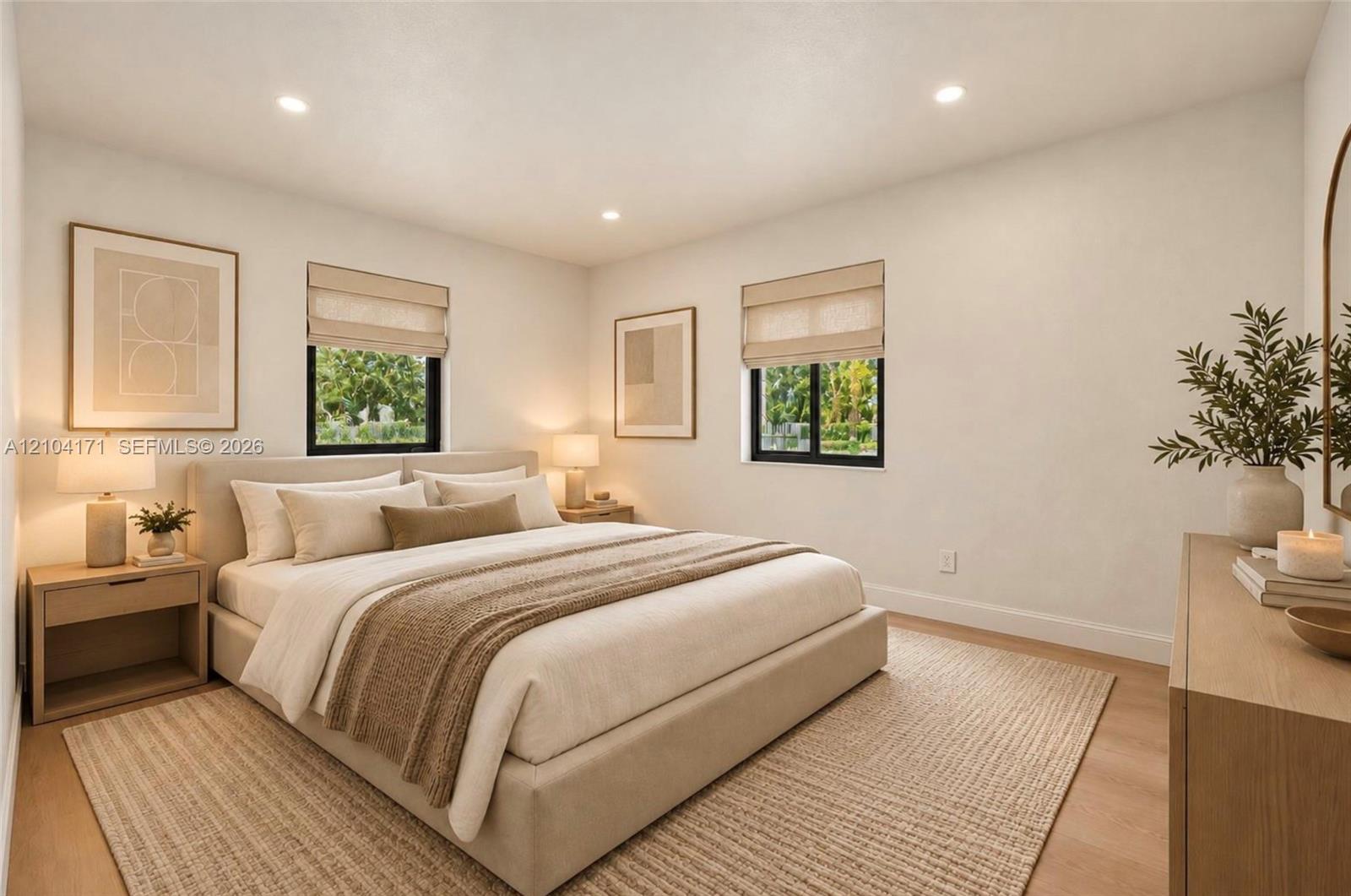 Neutral-toned room featuring recessed ceiling lighting, light wood-finish flooring, and black-framed windows