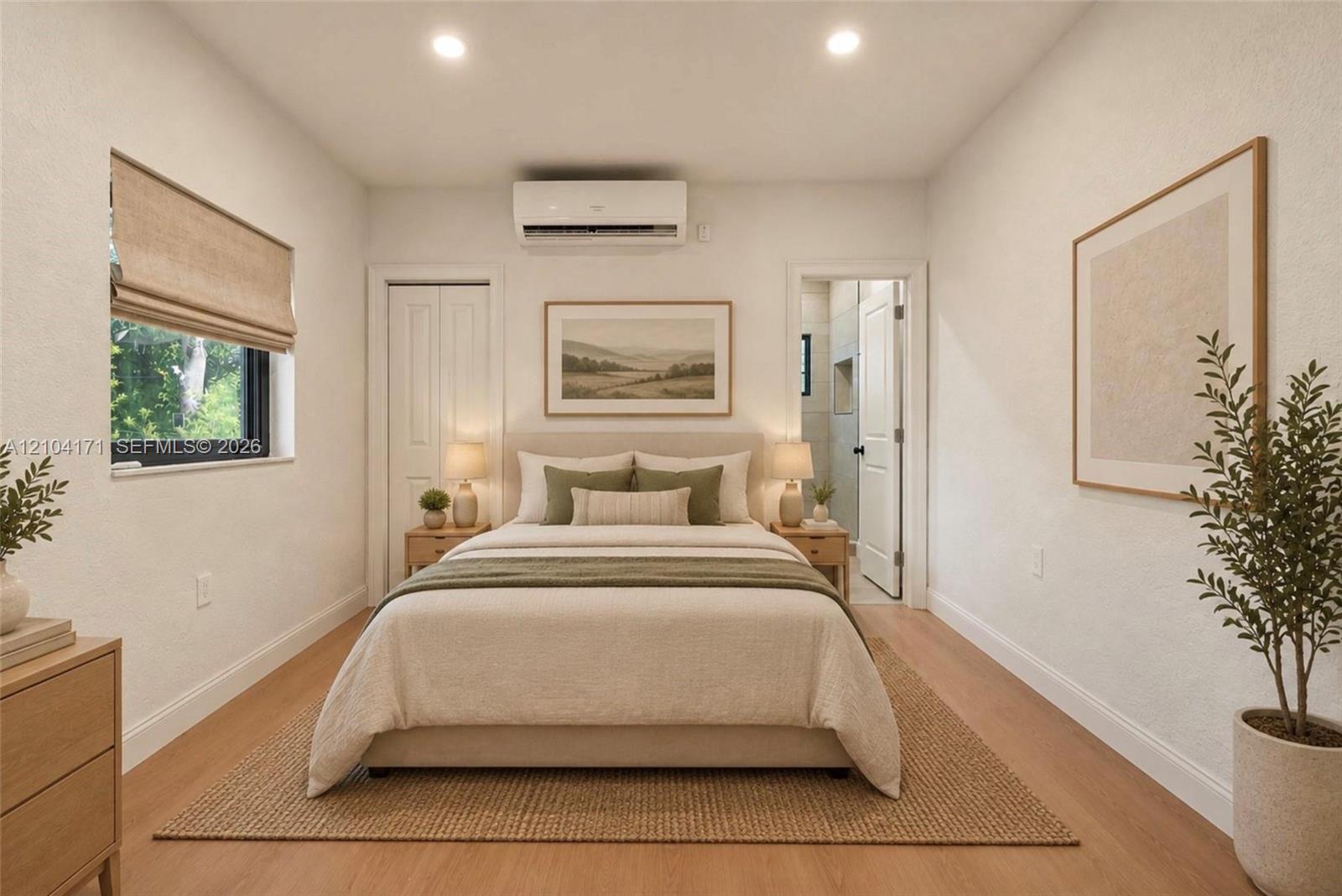 Room featuring wood-finish flooring, a wall-mounted ductless air conditioning unit, recessed ceiling lighting, and a window with a fabric shade