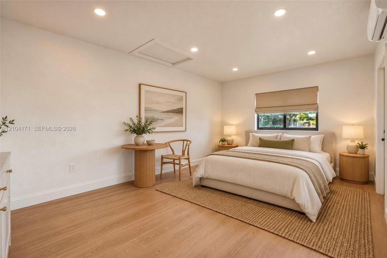 Room featuring wood-finish flooring, recessed lighting, and a window with a built-in window shade