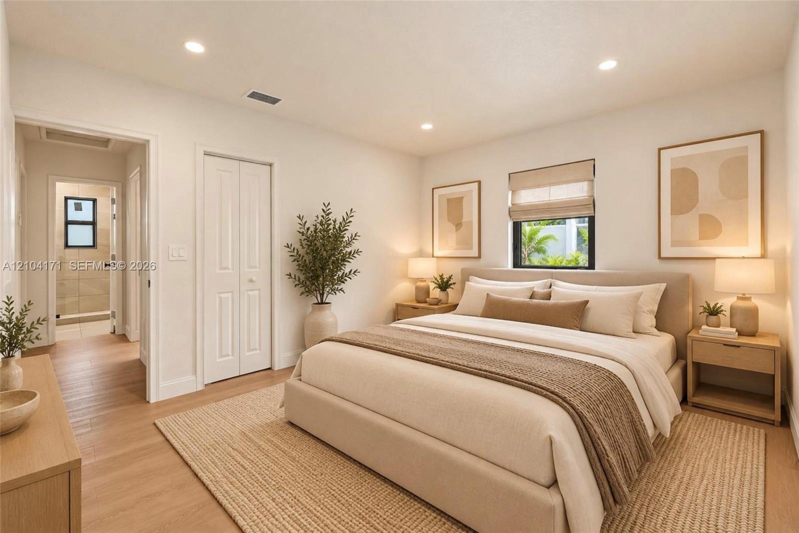 Neutral-toned interior featuring recessed lighting, wood-finish flooring, and a window with a roller shade