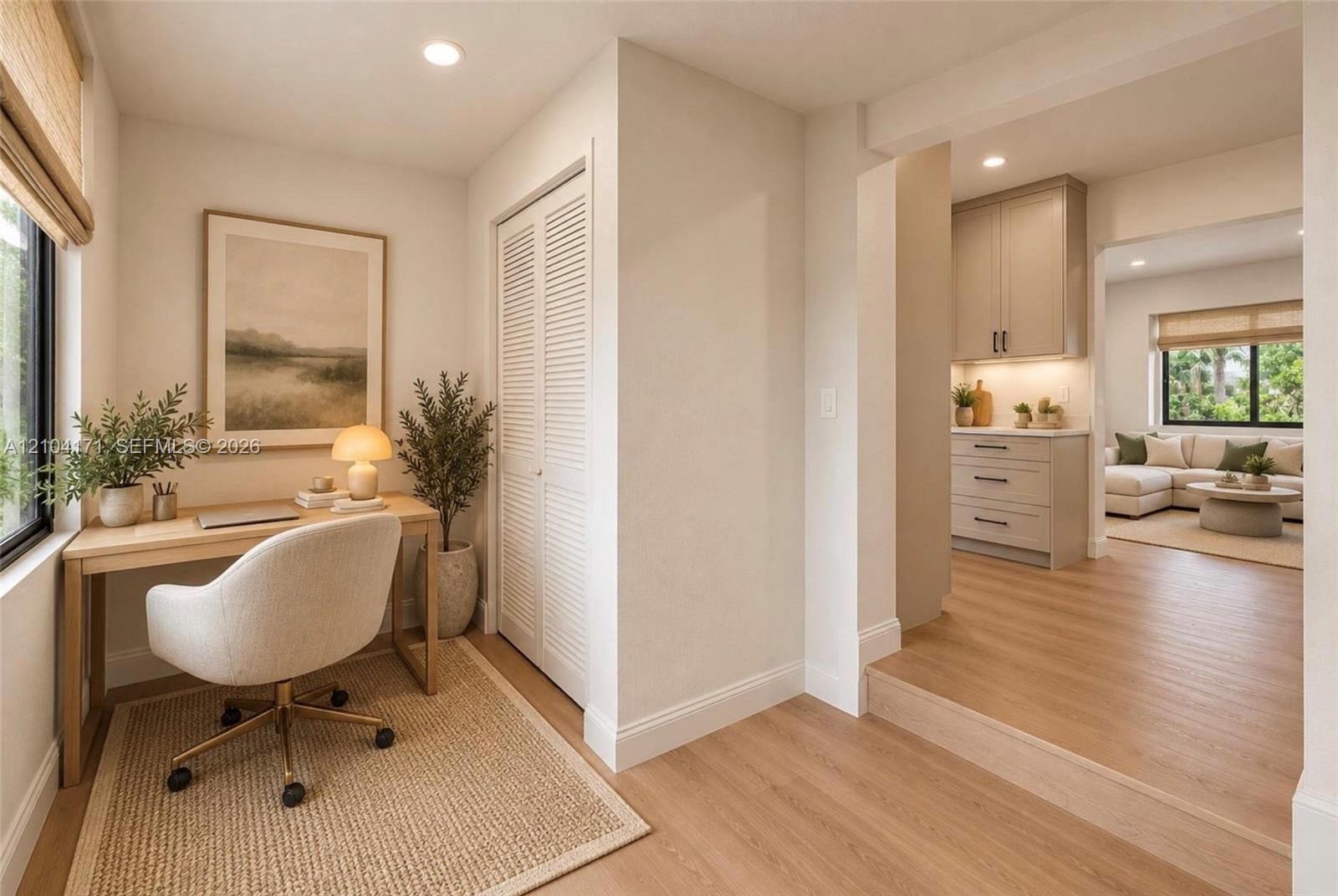 Wood-finish flooring, louvered-panel closet doors, recessed lighting, and built-in cabinetry featuring soft-close drawers and under-cabinet lighting