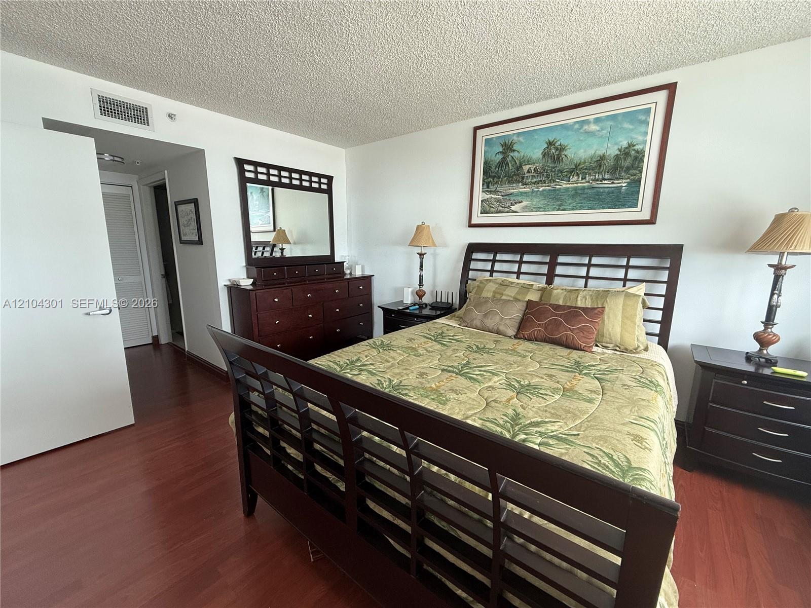 Interior space featuring dark wood-finish flooring and white walls Interior space featuring dark wood-finish flooring and white walls