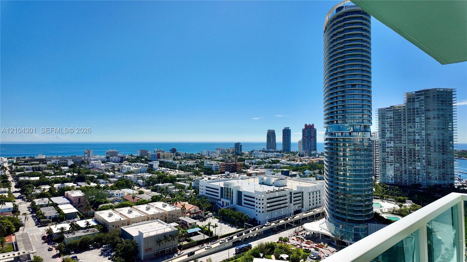 Elevated coastal landscape featuring expansive ocean horizons, panoramic urban architecture, and glass-railed balcony structures
