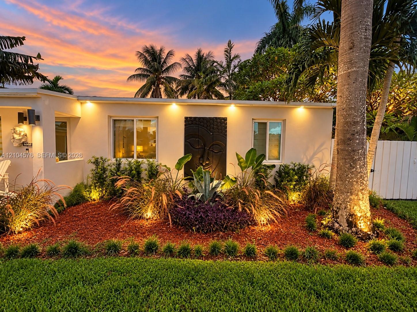 Exterior elevation featuring smooth stucco siding, low-profile soffit lighting, and custom relief wall art Exterior elevation featuring smooth stucco siding, low-profile soffit lighting, and custom relief wall art
