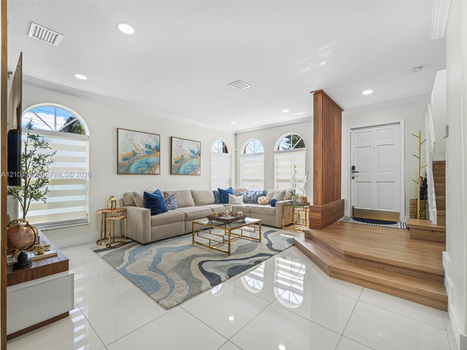 Polished porcelain tile flooring, wood-finish raised entryway platform with integrated slat room divider, recessed ceiling lighting, and multiple arched windows Polished porcelain tile flooring, wood-finish raised entryway platform with integrated slat room divider, recessed ceiling lighting, and multiple arched windows