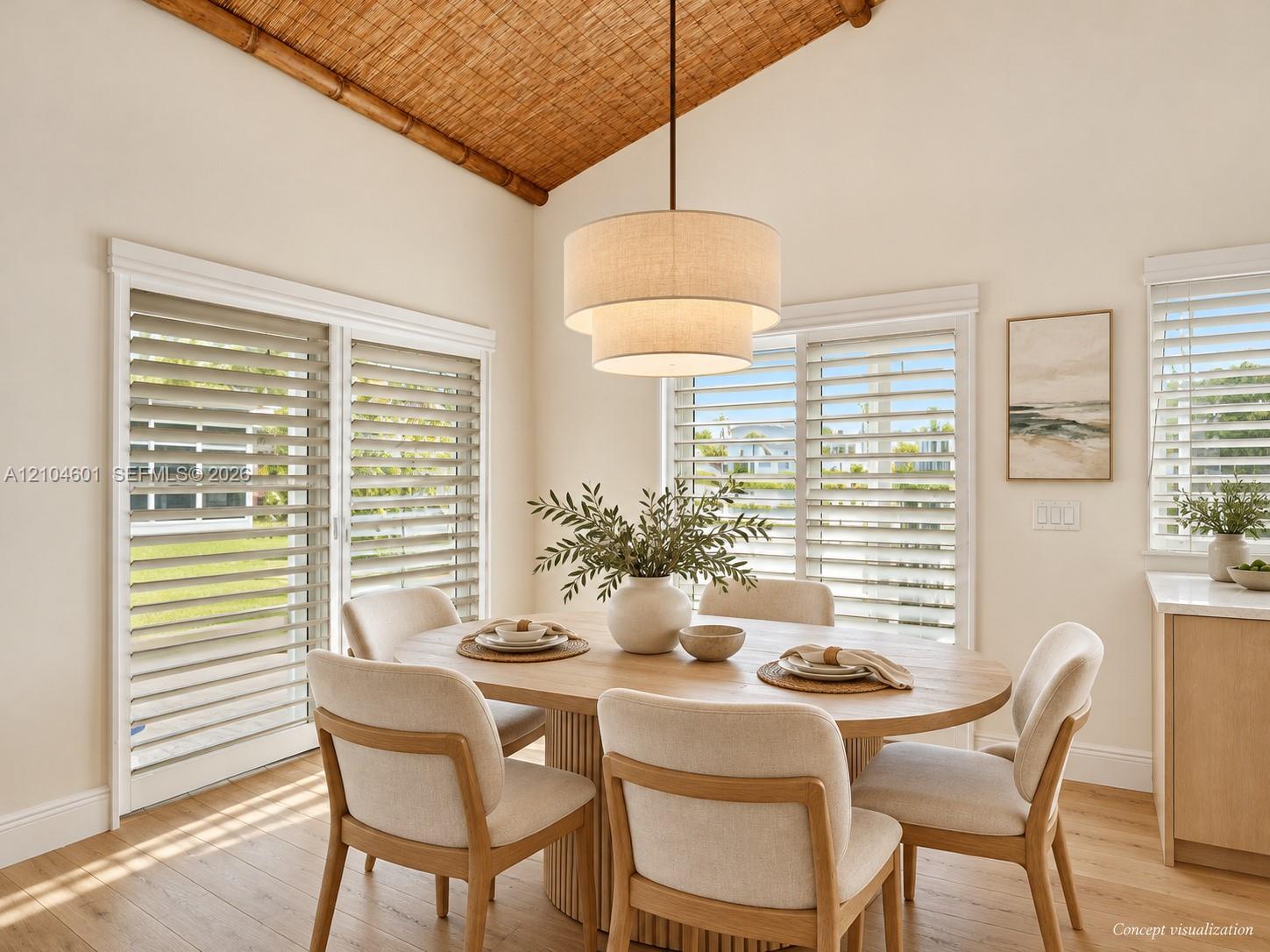 Vaulted ceiling featuring a woven texture finish, wood-finish flooring, three-tier pendant lighting, and oversized sliding glass doors equipped with horizontal blinds