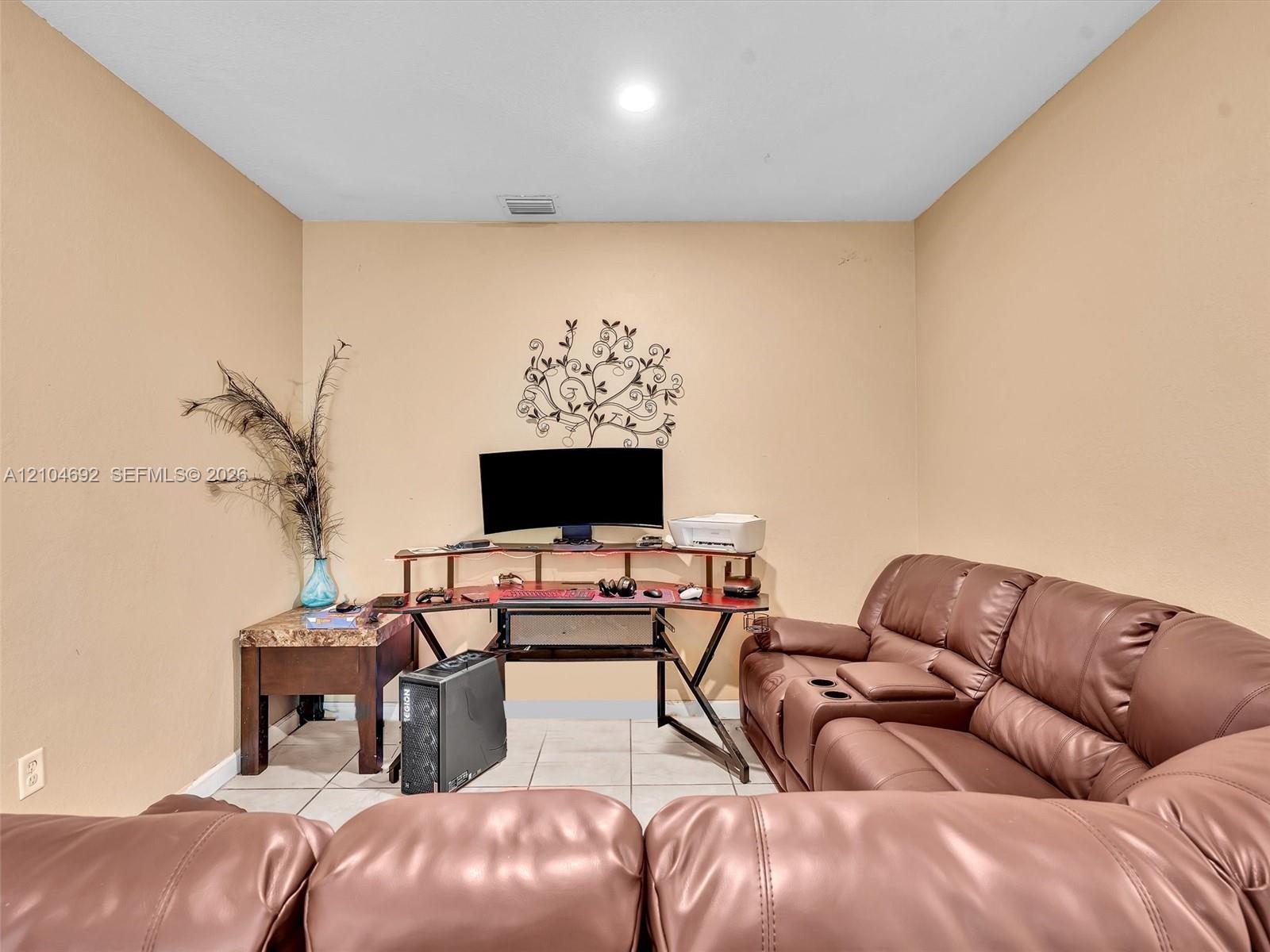 Neutral-toned interior room featuring tile flooring and recessed ceiling lighting Neutral-toned interior room featuring tile flooring and recessed ceiling lighting