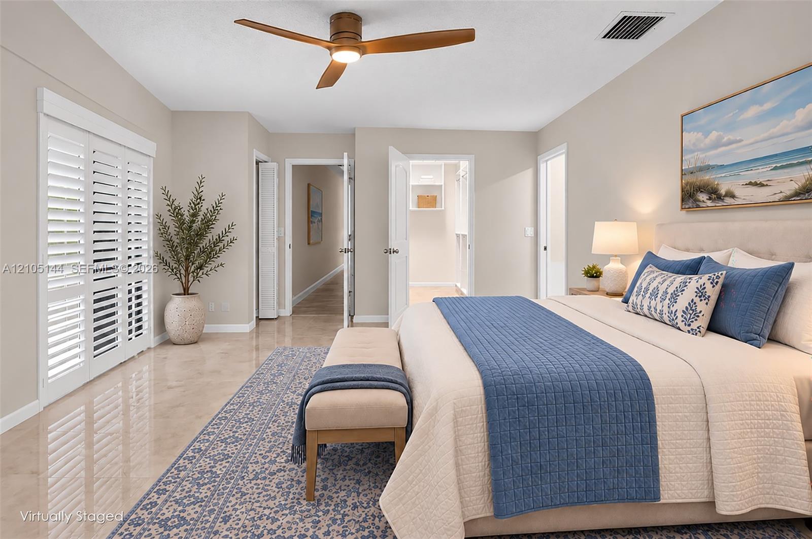 Neutral interior featuring polished stone flooring, three-blade ceiling fan with integrated lighting, and white plantation shutters