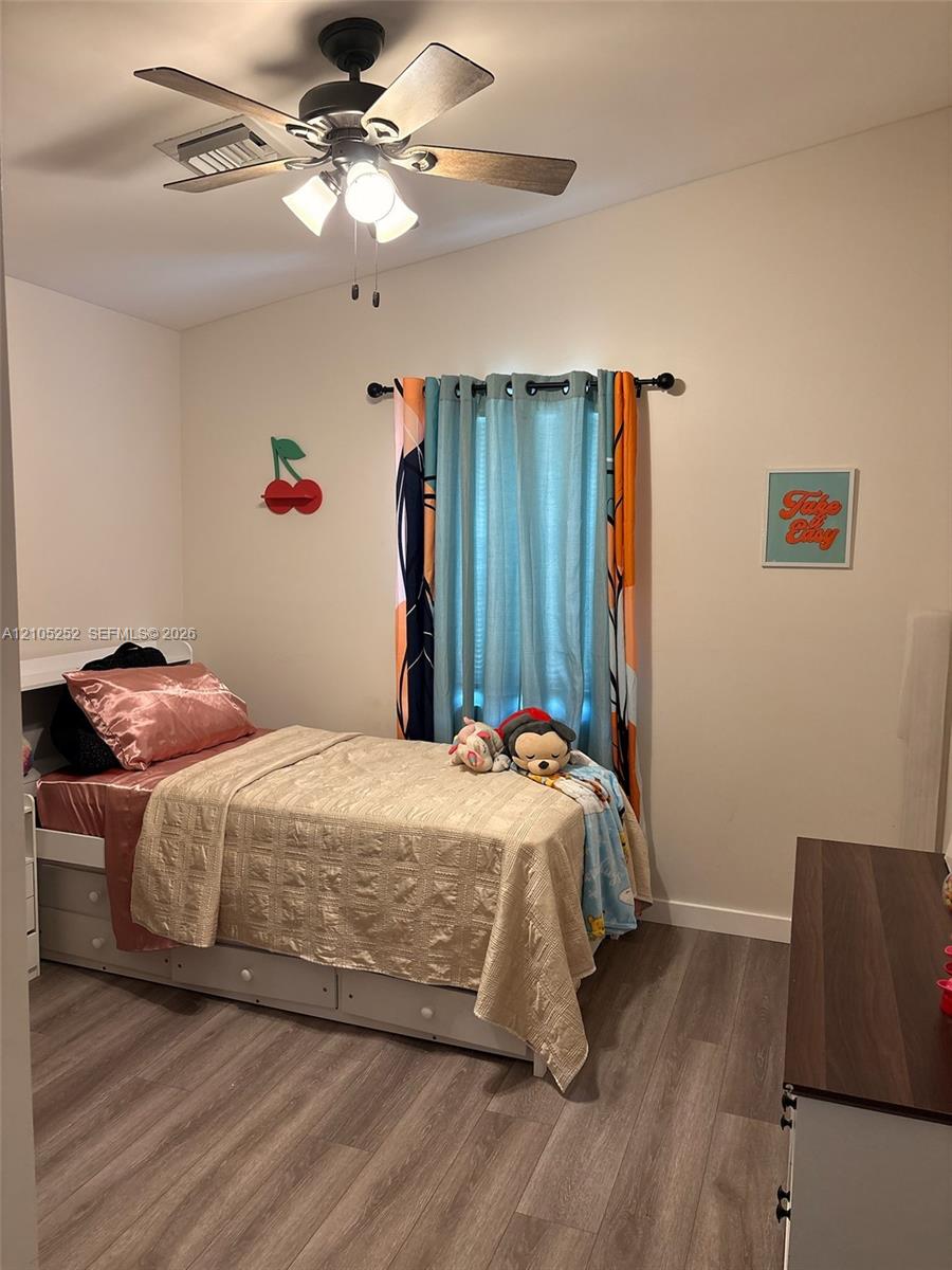 Wood-finish flooring with a neutral paint palette and crown molding
