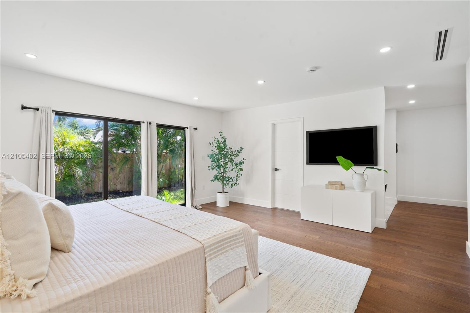 Interior space featuring wood-finish flooring, recessed lighting, and large sliding glass doors