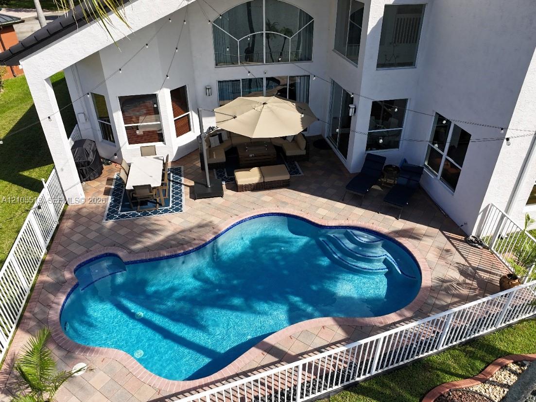 Inviting swimming pool with integrated steps, surrounded by a paver patio