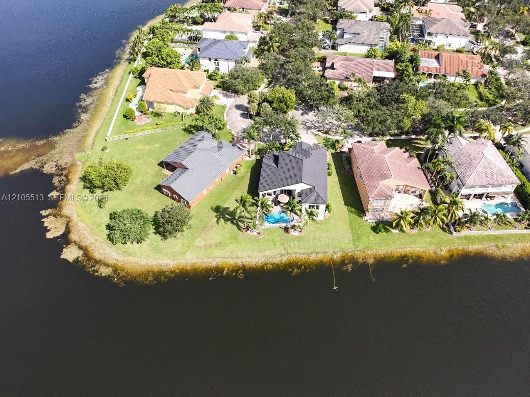 Waterfront properties featuring private swimming pools, mature landscaping, and an established neighborhood setting