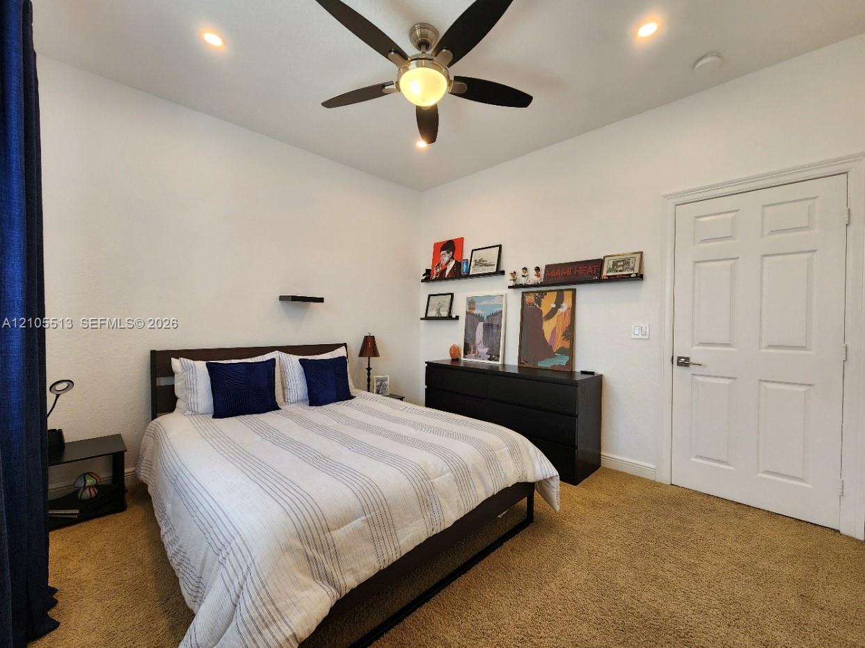 2nd Floor Guest Bedroom w/Recessed lighting, ceiling fan with integrated light, warm-toned carpet flooring, and a six-panel interior door