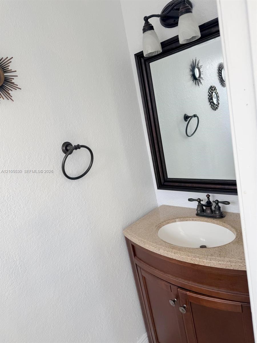 Wood-finish vanity with an integrated sink and countertop