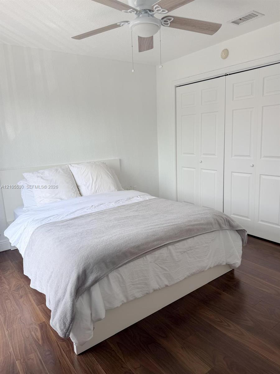 Wood-finish flooring, ceiling fan with light fixture, and bi-fold closet doors